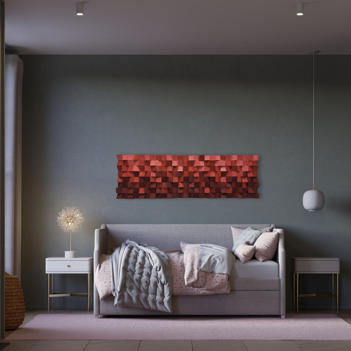 A modern living room setting featuring a rectangular wall art piece with a 3D geometric block pattern in shades of red and orange, mounted on a dark gray wall above a gray sofa.